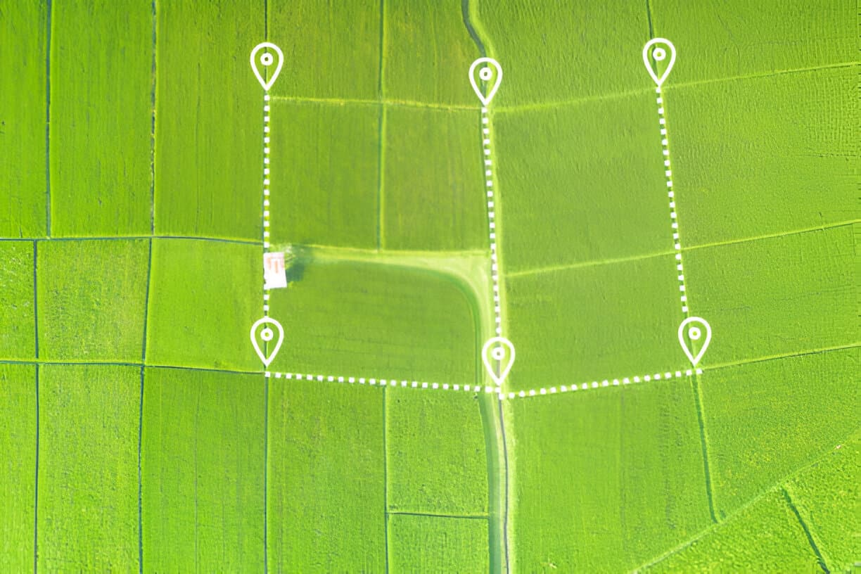 Aerial view of farmland subdivided into plots with marked boundaries